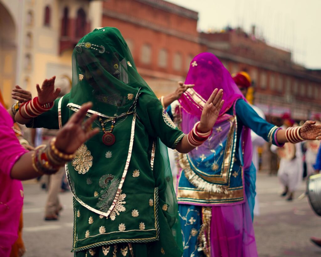 PRA Odisha Distributes Scholarships to 25 Underprivileged Students in Bhubaneswar Women in vibrant traditional clothing performing a cultural dance at a street festival.